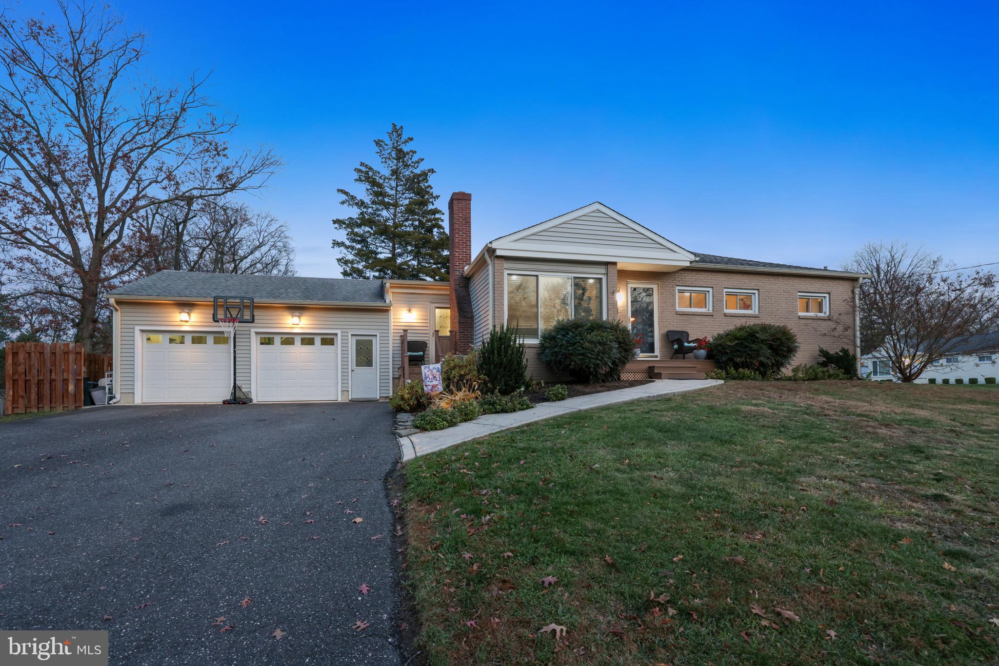 709 Manor Terrace Moorestown, NJ 08057 - Photo 34 of 37 a front view of a house with a yard and garage