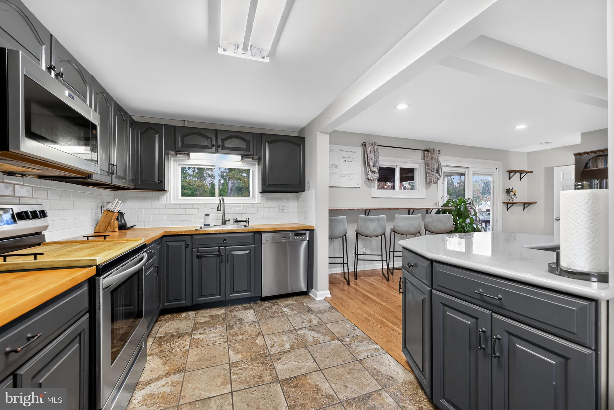 709 Manor Terrace Moorestown, NJ 08057 - Photo 9 of 37 a kitchen with stainless steel appliances granite countertop a sink counter space cabinets and a large window