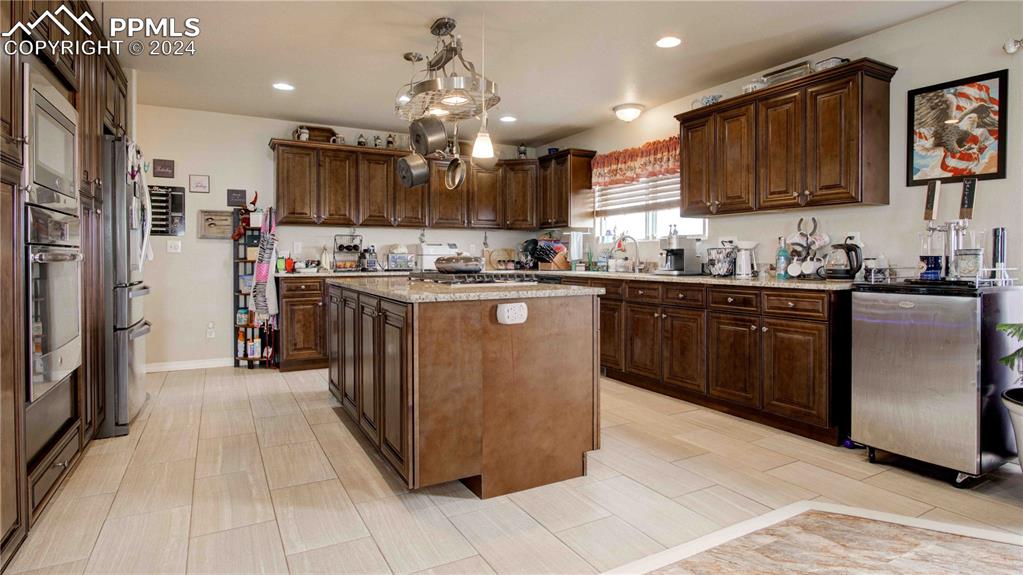 38115 Gieck Road Rush, CO 80833 - Photo 11 of 46 a kitchen with stainless steel appliances granite countertop a stove top oven a sink dishwasher and a refrigerator