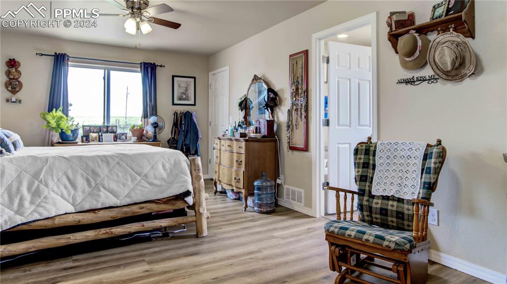 38115 Gieck Road Rush, CO 80833 - Photo 18 of 46 a bedroom with furniture and a wooden floor