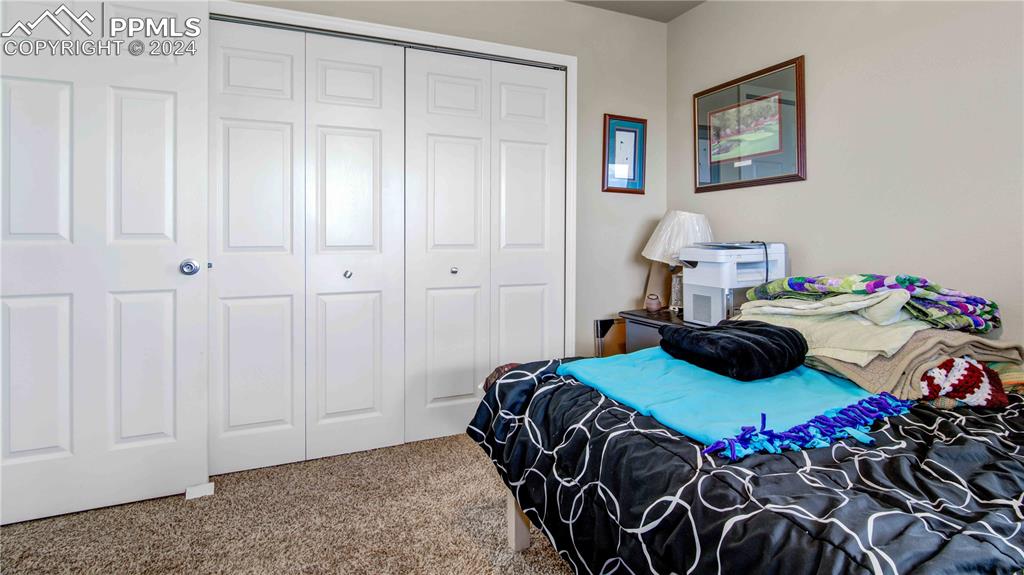 38115 Gieck Road Rush, CO 80833 - Photo 28 of 46 a bedroom with a bed and a painting on the wall