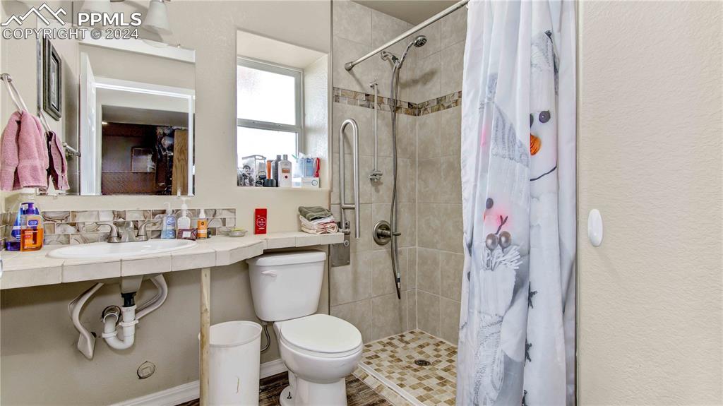 38115 Gieck Road Rush, CO 80833 - Photo 30 of 46 a bathroom with a sink toilet and shower