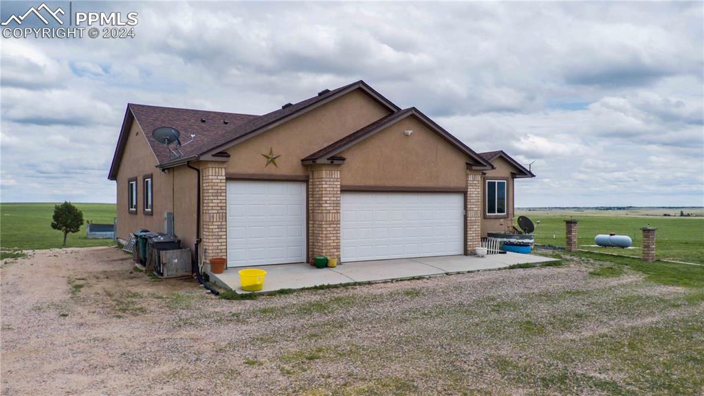 38115 Gieck Road Rush, CO 80833 - Photo 5 of 46 a view of a house with a small yard and a large tree