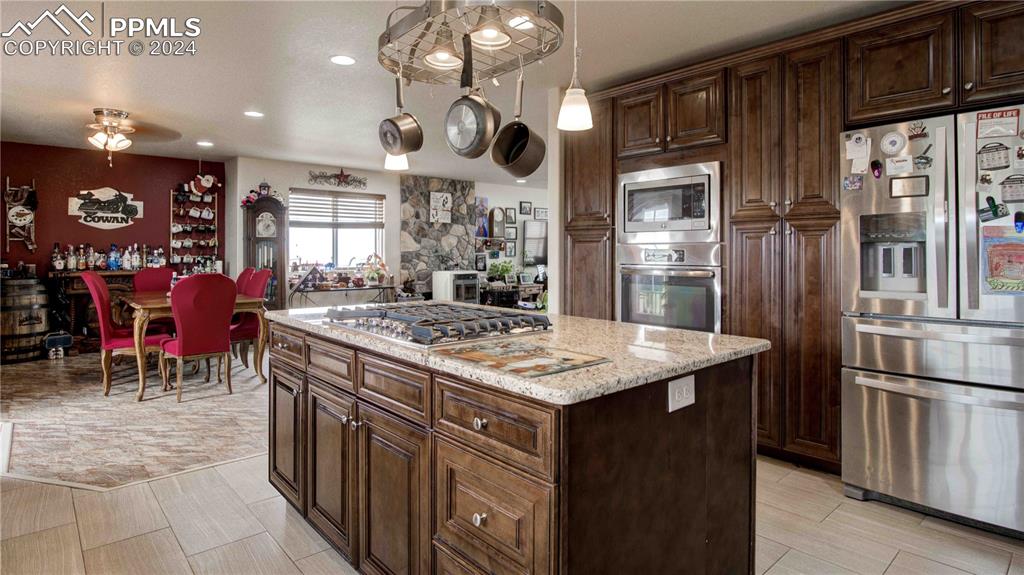 38115 Gieck Road Rush, CO 80833 - Photo 10 of 46 a kitchen with stainless steel appliances granite countertop a stove refrigerator and cabinets