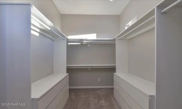 a bathroom with a granite countertop double vanity sink a mirror and bathtub