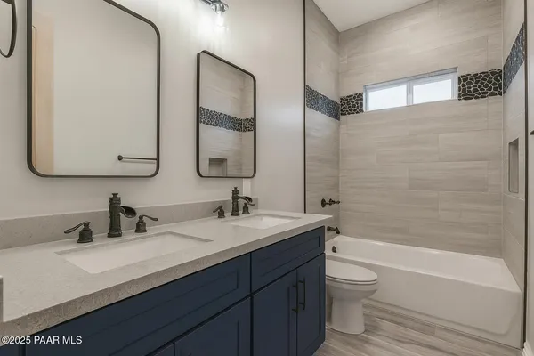 a bathroom with a granite countertop toilet sink and a mirror