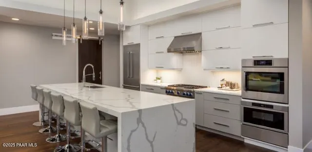 an empty room with windows and fireplace