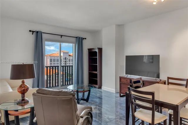 a view of a livingroom with furniture and a flat screen tv