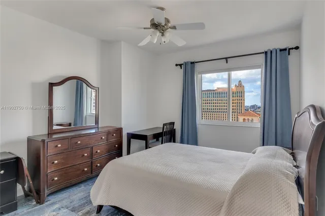 a bedroom with a bed a dresser and a mirror