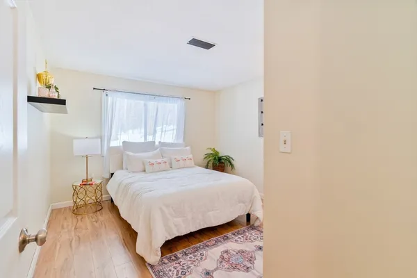 a bedroom with a bed and a window