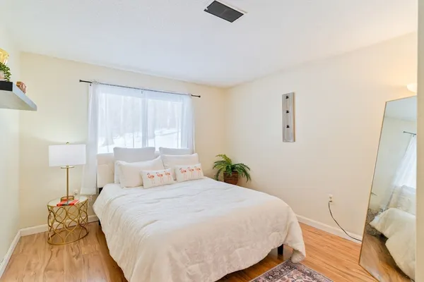 a bedroom with a bed and a lamp