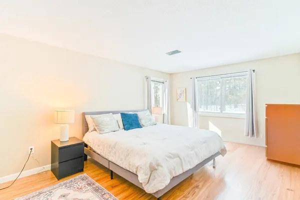 a bedroom with a large bed and a large window