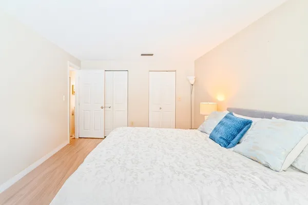 a bedroom with a bed and a night stand