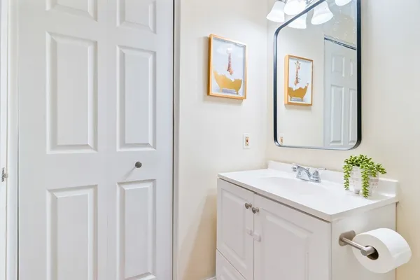 a bathroom with a sink vanity and a mirror