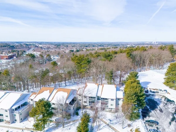 an aerial view of lake and residential houses with outdoor space