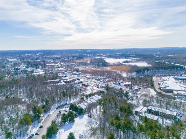 an aerial view of residential building and trees around