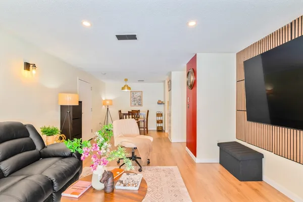 a living room with furniture and a flat screen tv