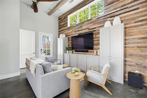 a living room with furniture a flat screen tv and a fireplace