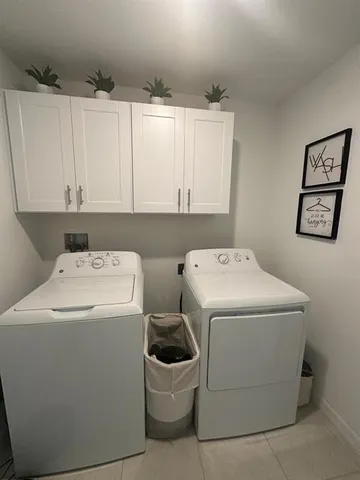 a living room with furniture and a dining table with kitchen view