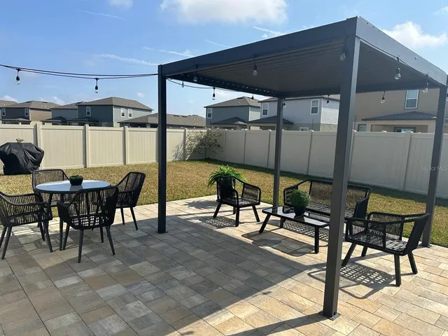 a view of a patio with table and chairs