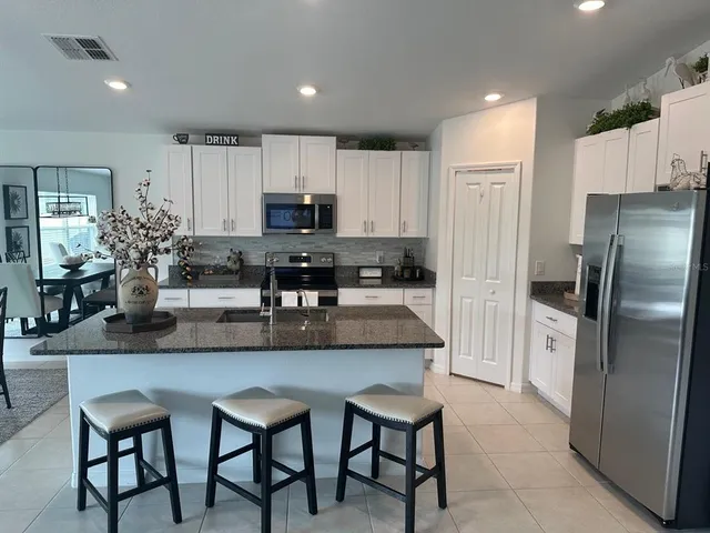 a kitchen with kitchen island cabinets and refrigerator
