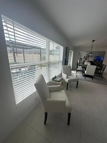 a living room with fireplace furniture and a chandelier