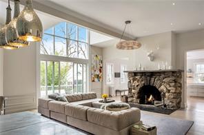 28 Park Avenue Bronxville, NY 10708 - Photo 1 of 1 a living room with furniture a fireplace and a chandelier