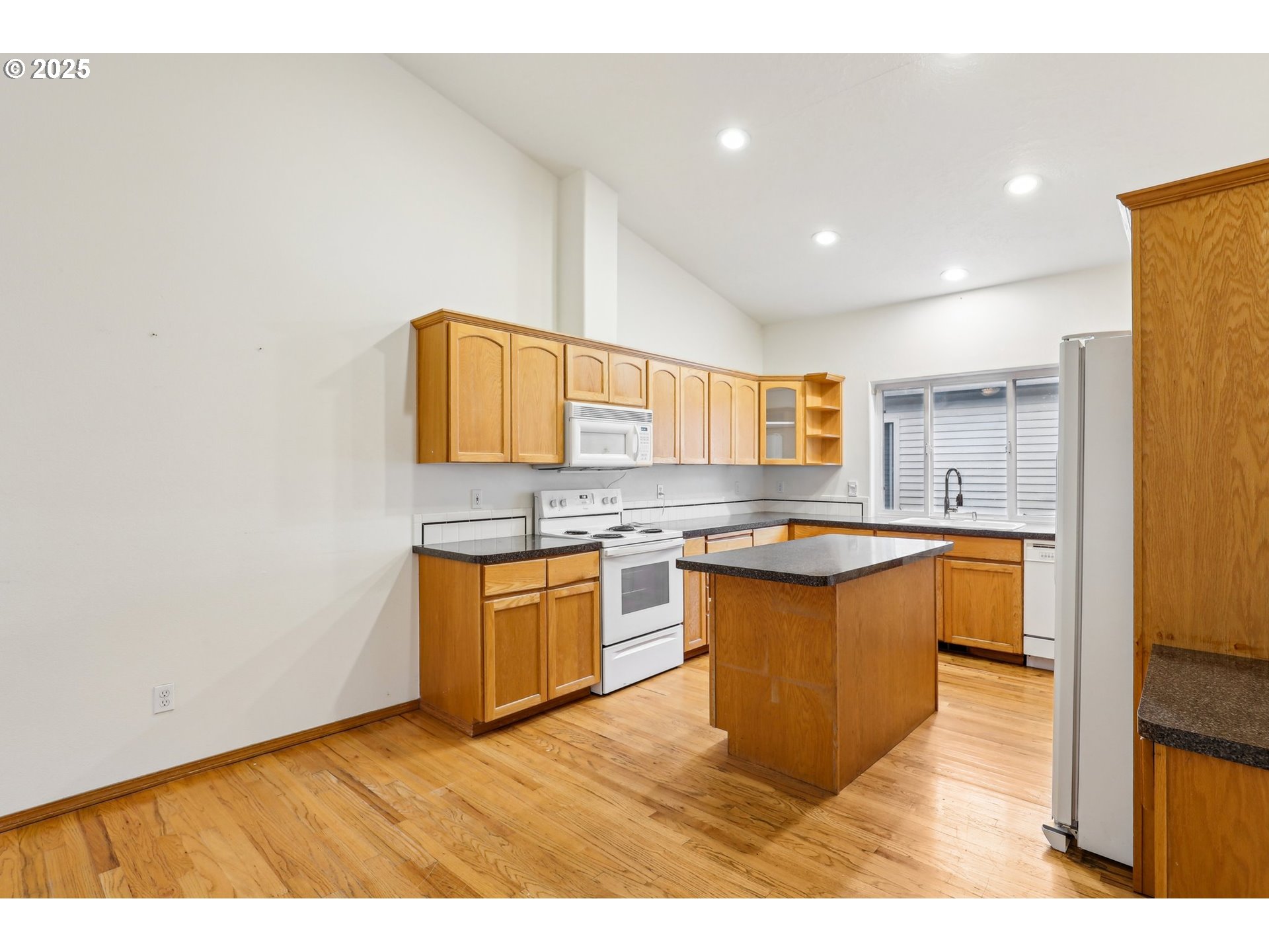 18222 Davis Street Sandy, OR 97055 - Photo 15 of 42 a large kitchen with stainless steel appliances granite countertop a sink and dishwasher a stove with wooden floor