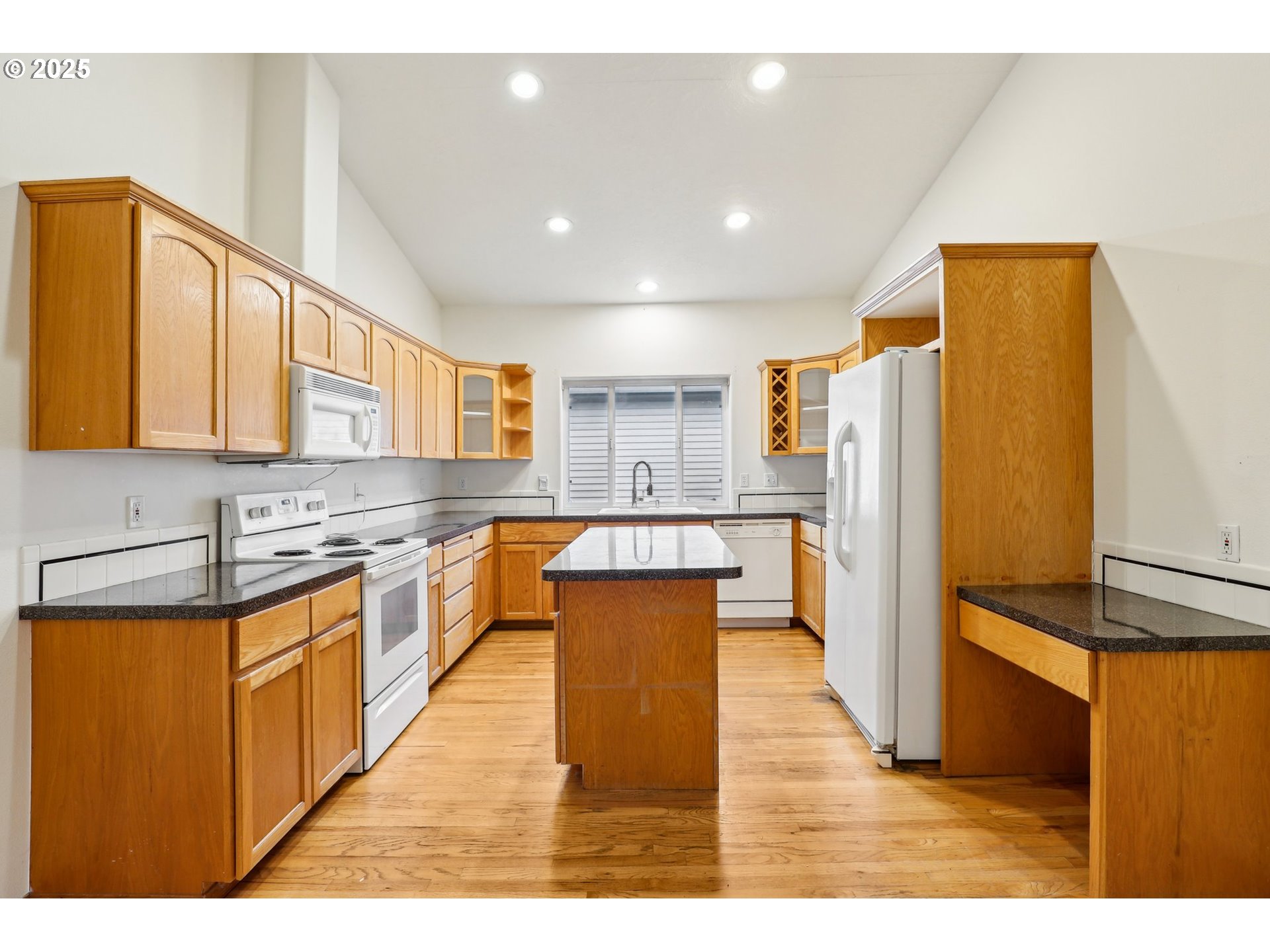 18222 Davis Street Sandy, OR 97055 - Photo 16 of 42 a kitchen with stainless steel appliances granite countertop a refrigerator a sink dishwasher a stove with wooden cabinets