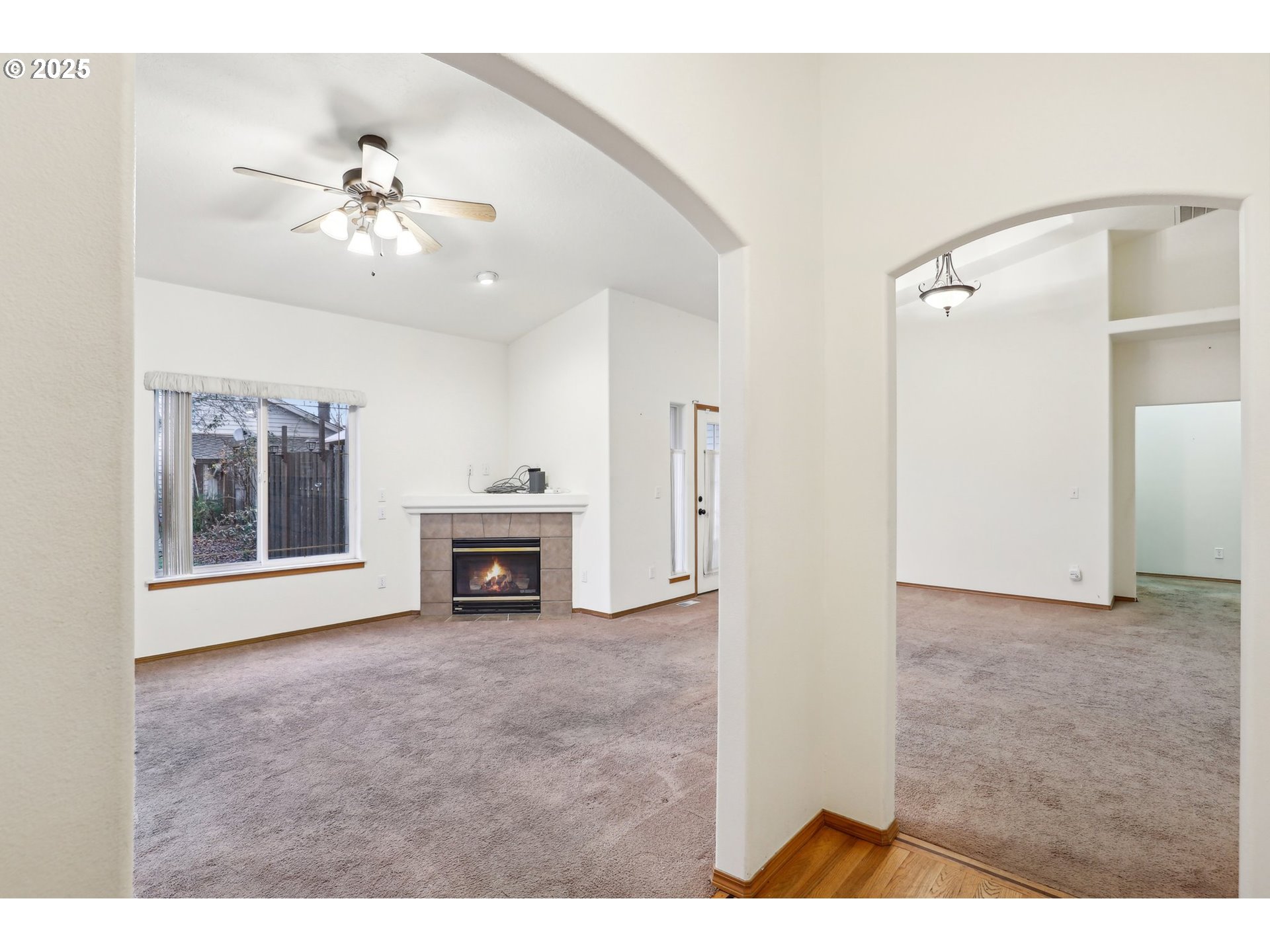 18222 Davis Street Sandy, OR 97055 - Photo 6 of 42 a view of a livingroom with a ceiling fan a fireplace and chandelier