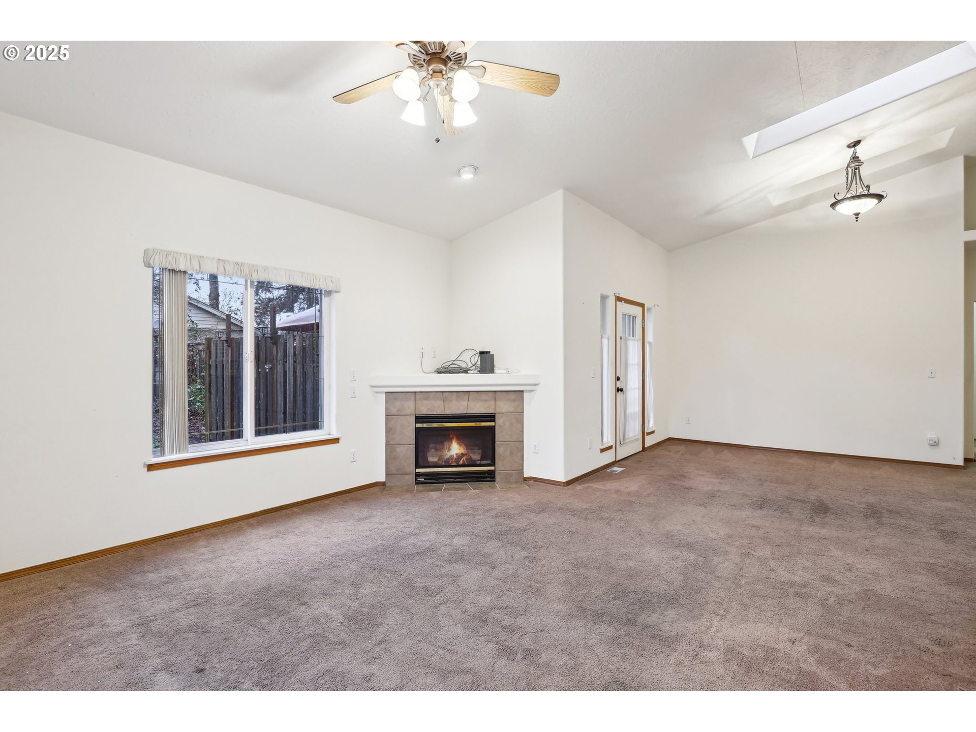 18222 Davis Street Sandy, OR 97055 - Photo 7 of 42 a view of an empty room with a fireplace and a window