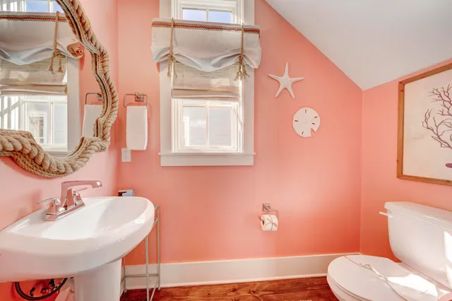 a bathroom with a sink a toilet and a mirror