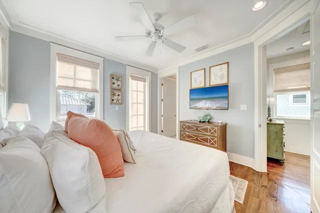 a bedroom with a large bed and a chandelier