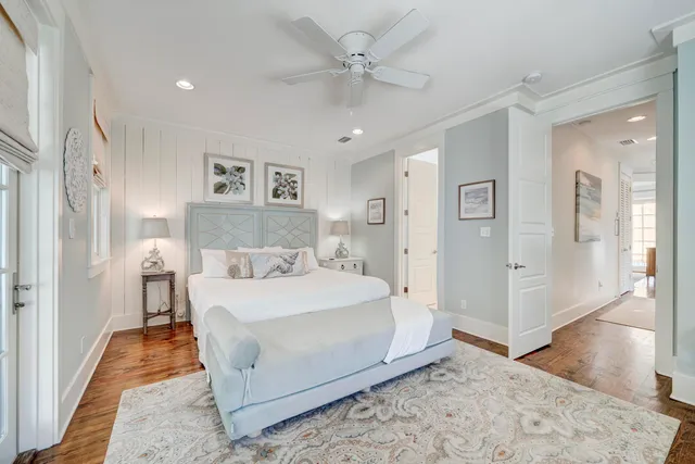 a spacious bedroom with a bed and a chandelier