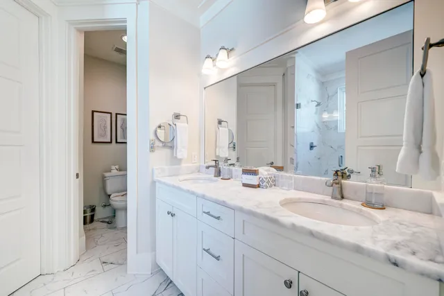 a spacious bathroom with a granite countertop sink and a mirror