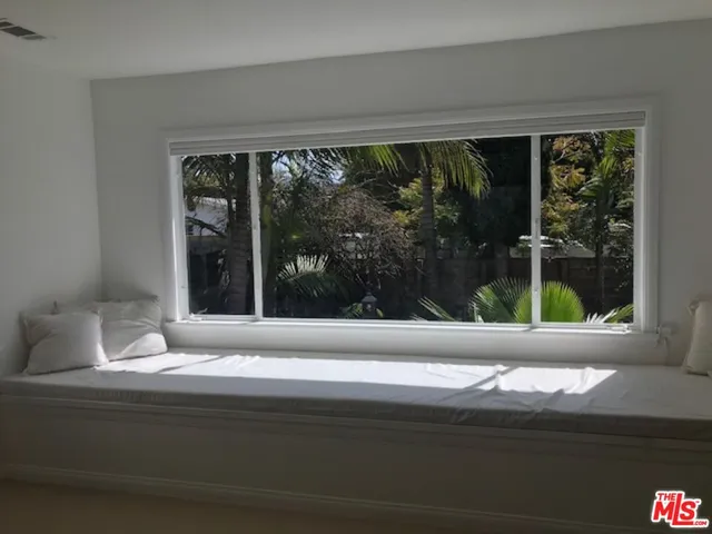 a living room with a large window and front door