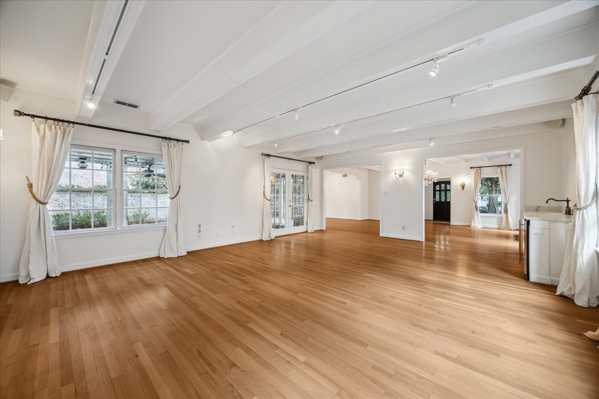 2117 Chilton Road Houston, TX 77019 - Photo 18 of 50 a view of an empty room with wooden floor and a window