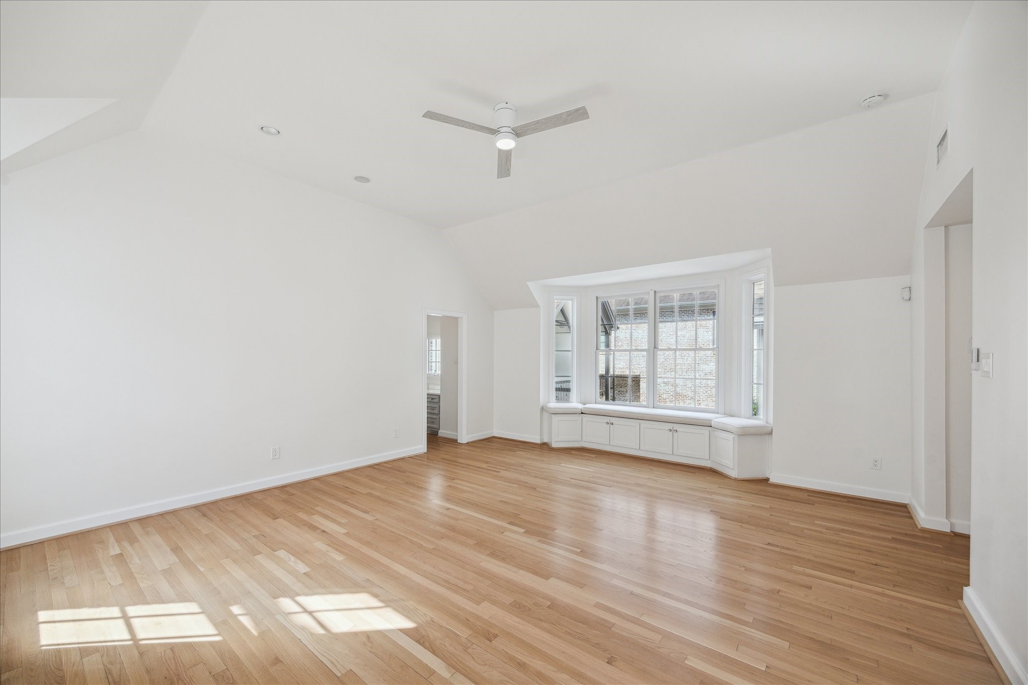 2117 Chilton Road Houston, TX 77019 - Photo 26 of 50 an empty room with wooden floor and windows
