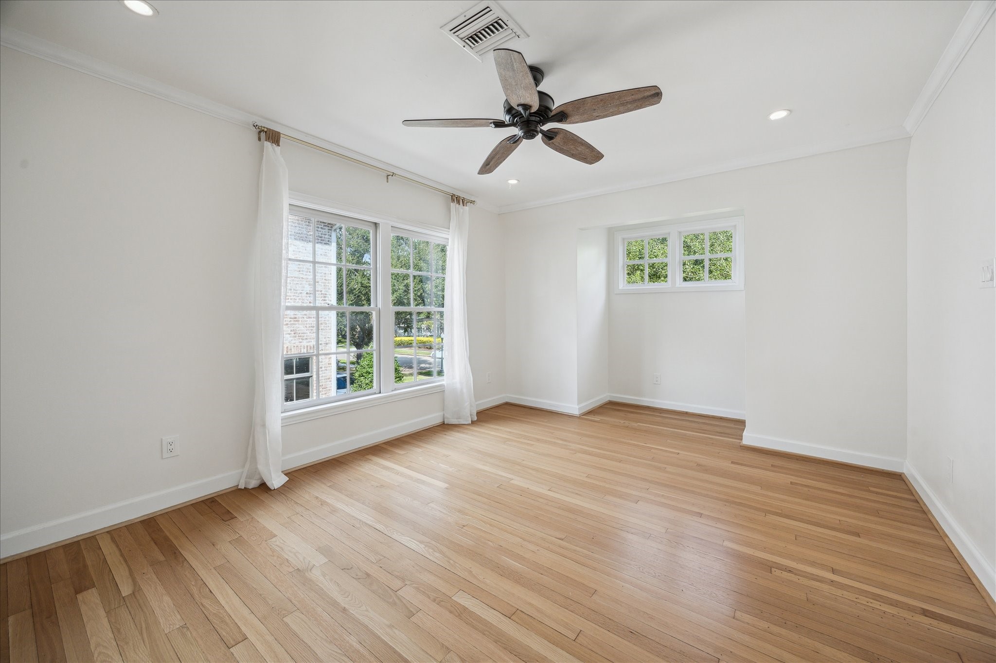 2117 Chilton Road Houston, TX 77019 - Photo 33 of 50 a view of an empty room with a window and wooden floor