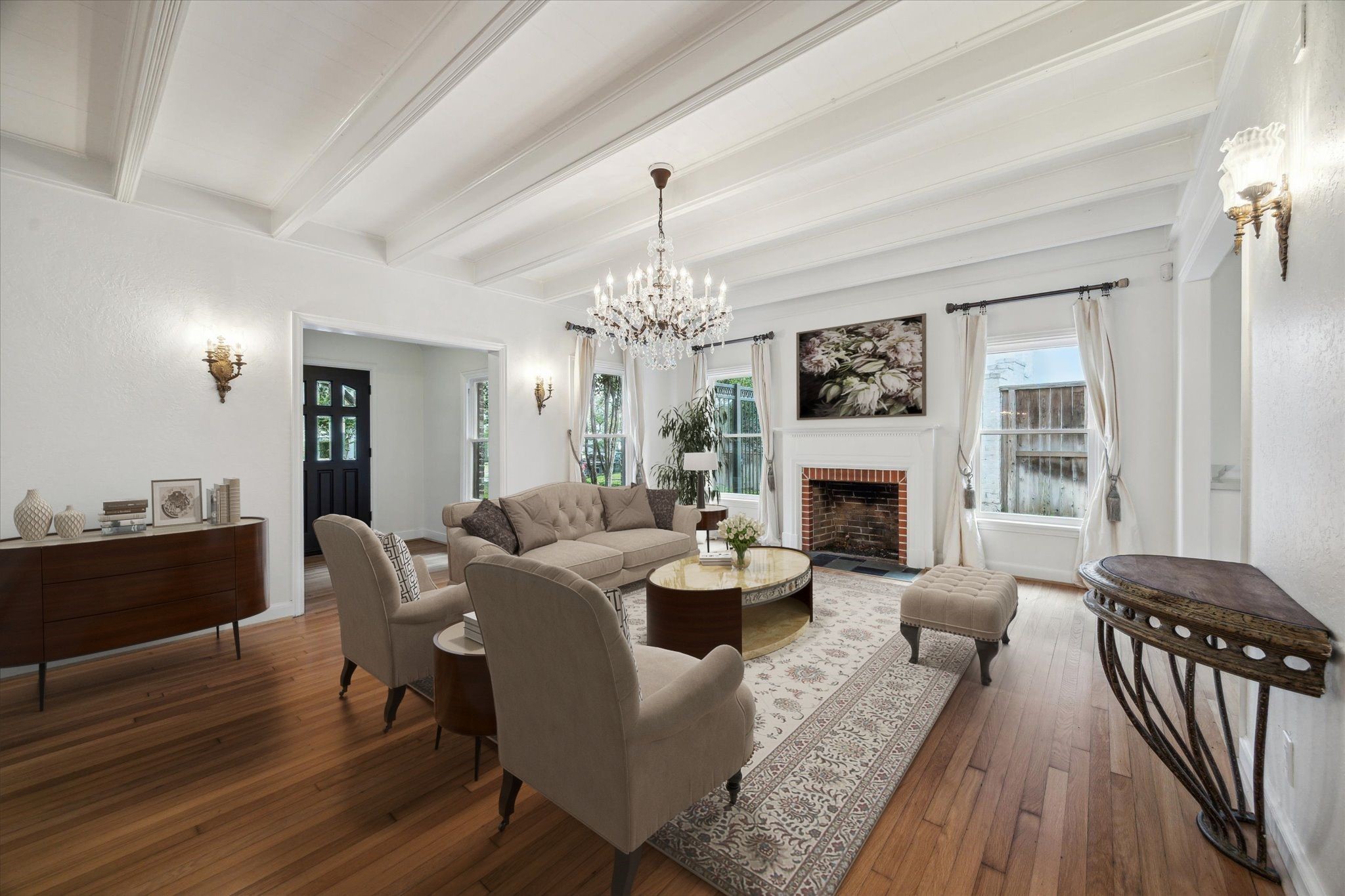 2117 Chilton Road Houston, TX 77019 - Photo 6 of 50 a living room with furniture a fireplace and a chandelier