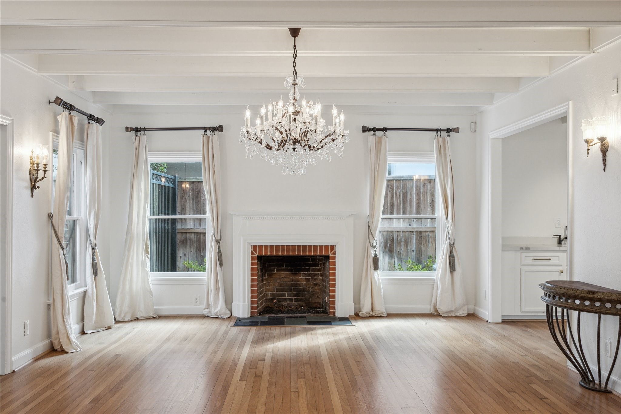 2117 Chilton Road Houston, TX 77019 - Photo 7 of 50 a view of a livingroom with wooden floor a fireplace and windows
