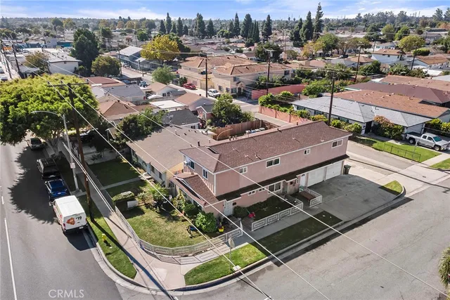 an aerial view of a house with a garden and large trees
