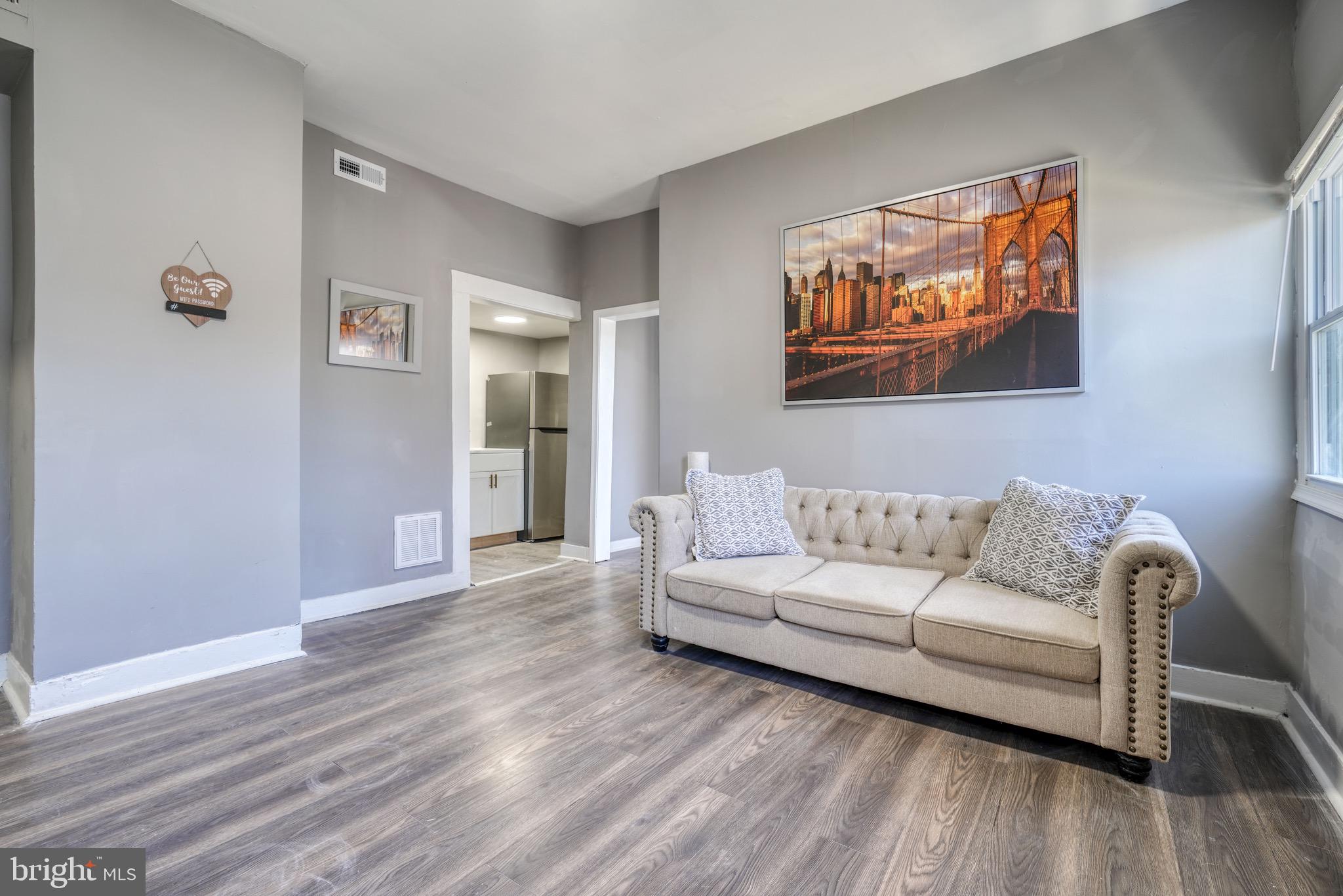 4107 Ridgewood Avenue Baltimore, MD 21215 - Photo 12 of 29 a living room with furniture and wooden floor