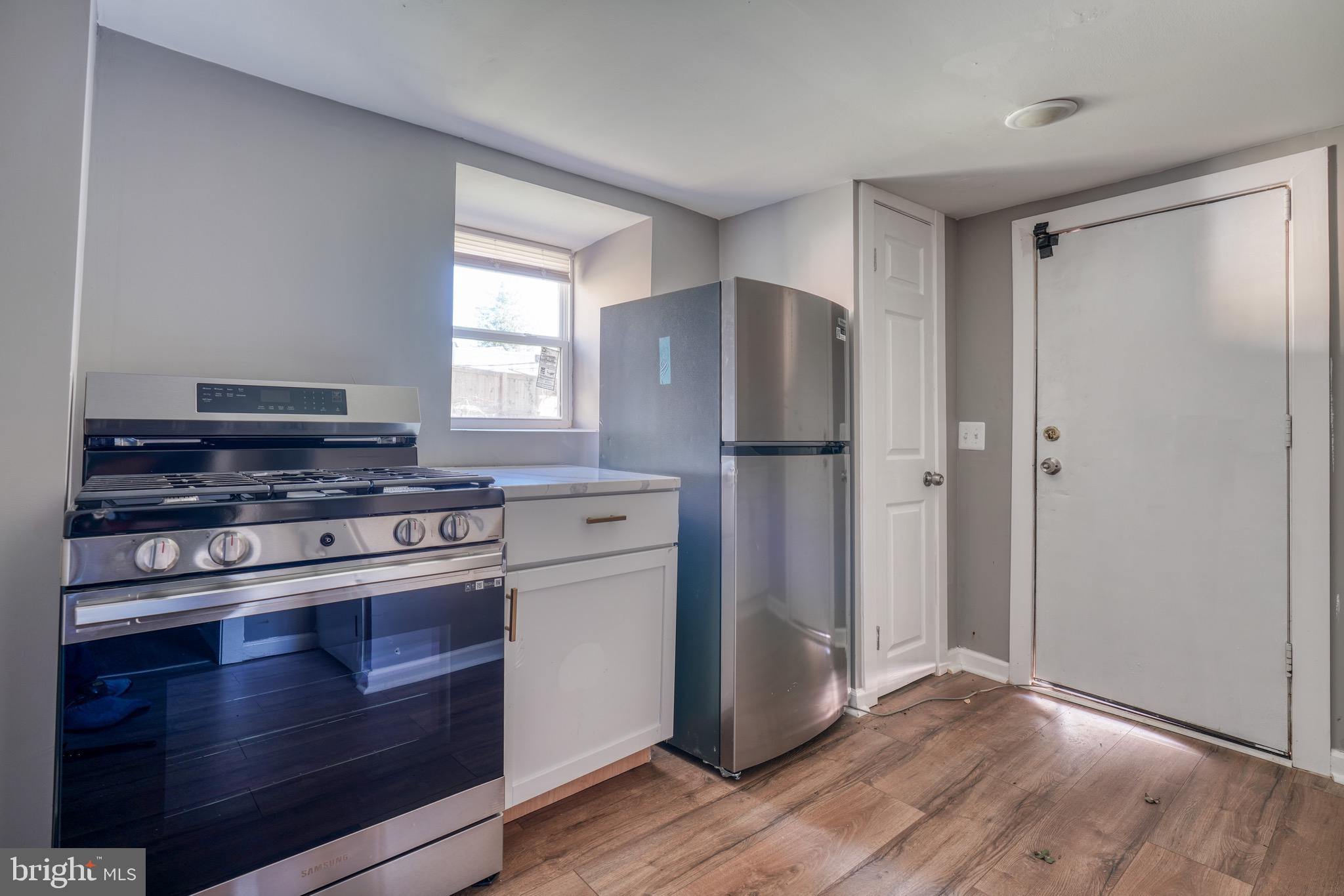 4107 Ridgewood Avenue Baltimore, MD 21215 - Photo 13 of 29 a kitchen with appliances a counter space and a window