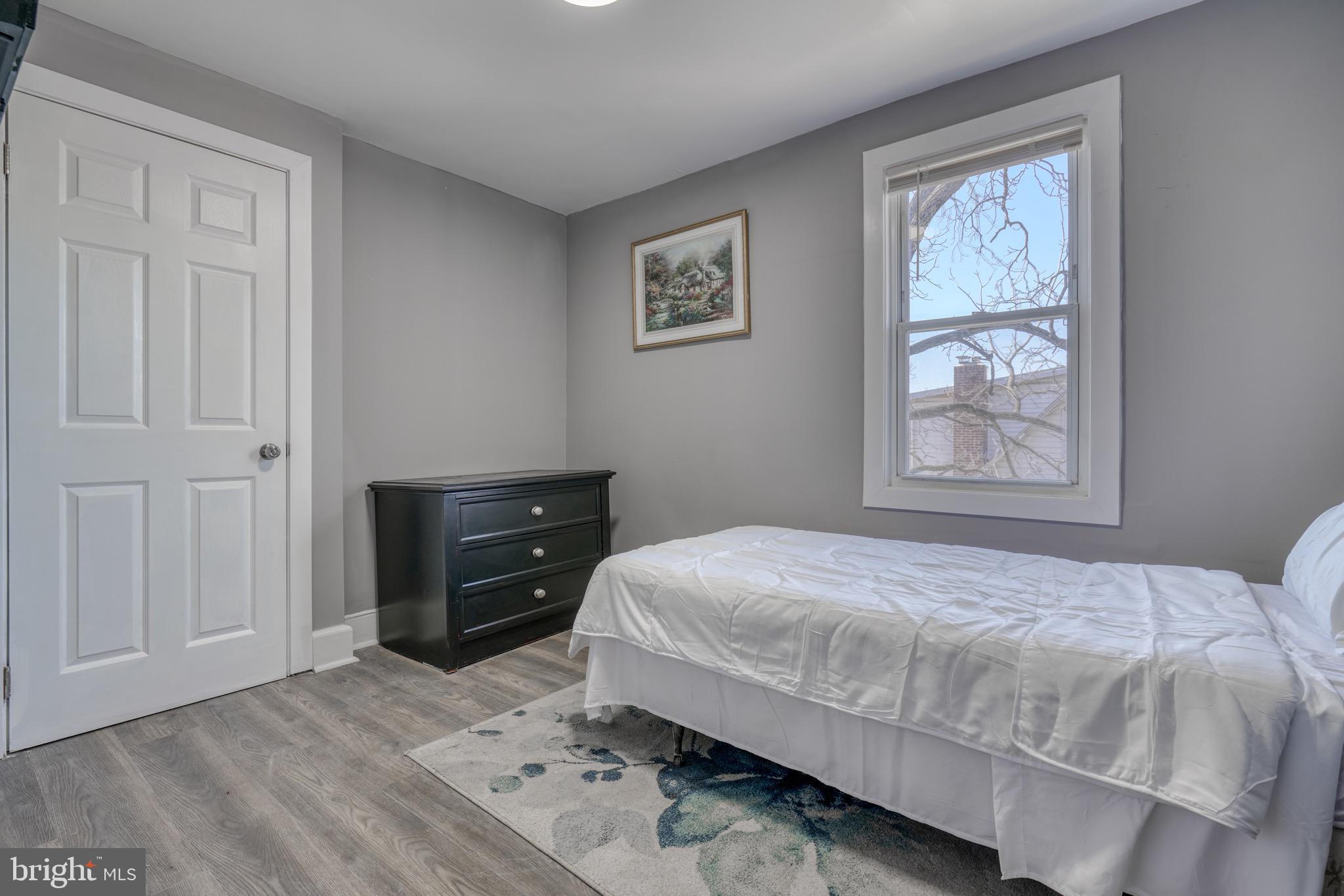 4107 Ridgewood Avenue Baltimore, MD 21215 - Photo 16 of 29 a bedroom with a bed and a window