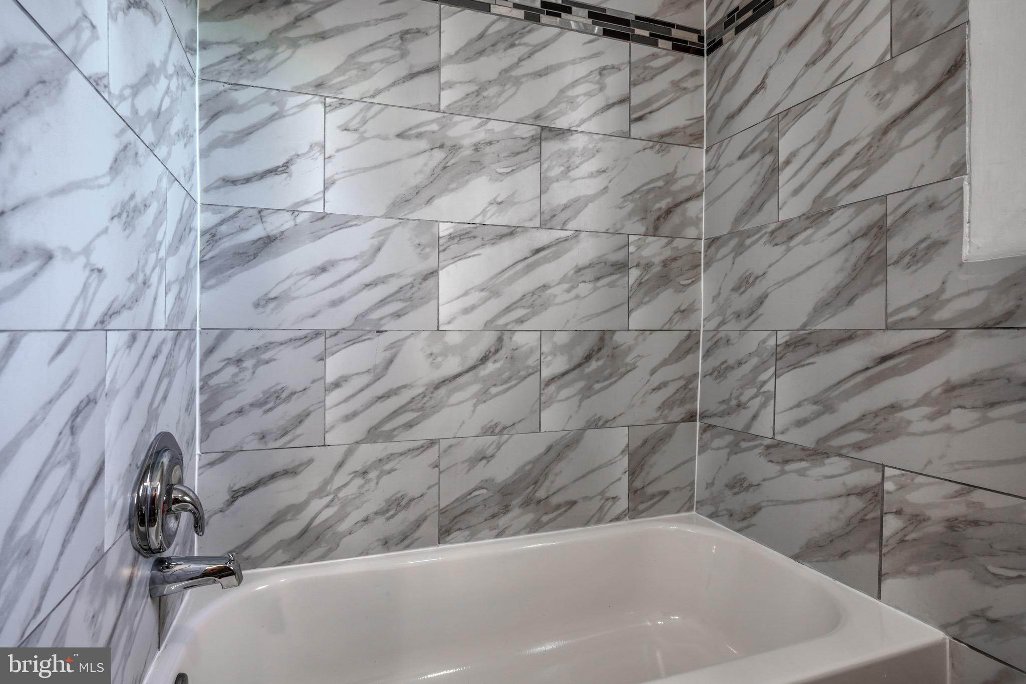 4107 Ridgewood Avenue Baltimore, MD 21215 - Photo 18 of 29 a bathroom with a bathtub