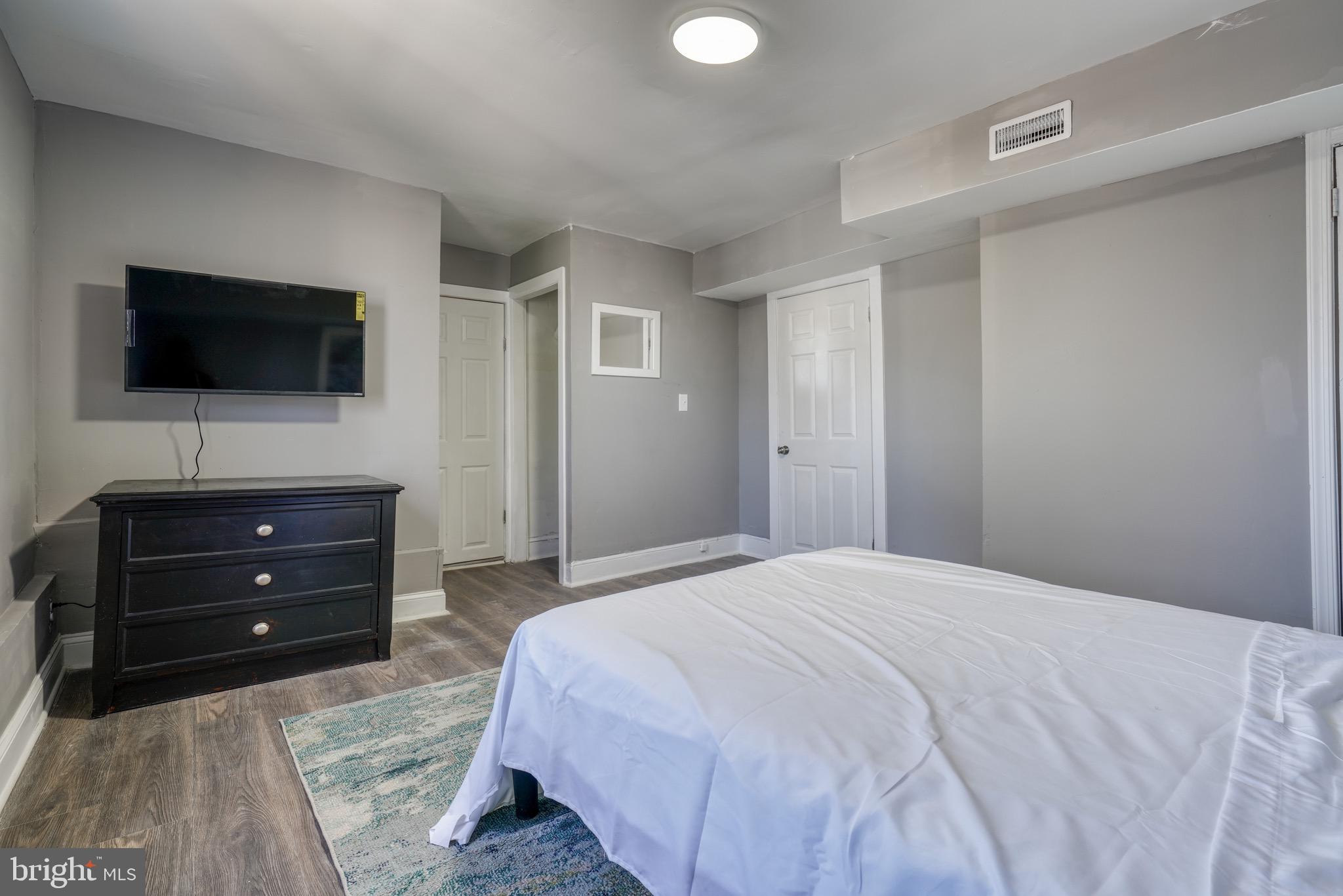 4107 Ridgewood Avenue Baltimore, MD 21215 - Photo 23 of 29 a bedroom with a bed and a flat screen tv