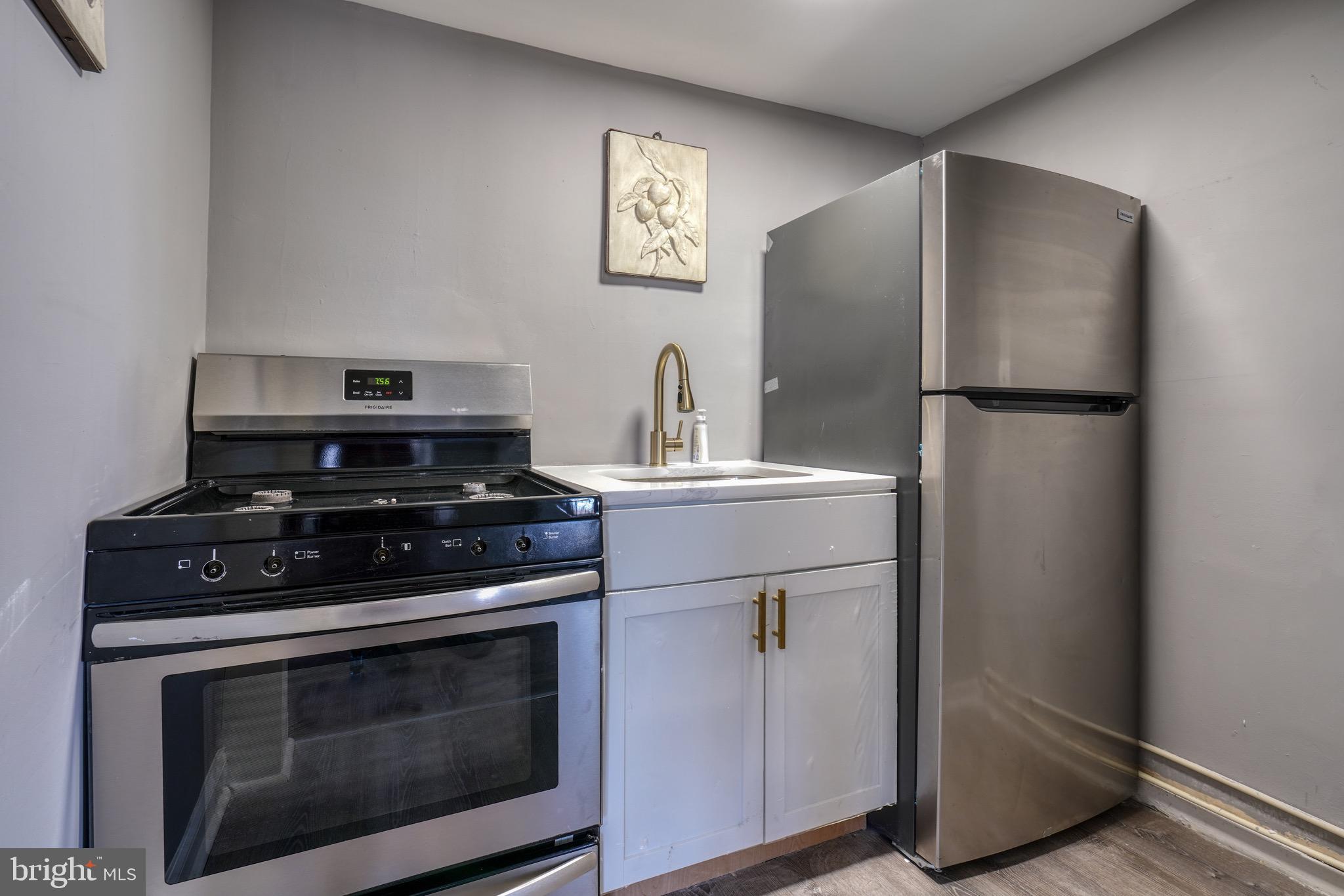 4107 Ridgewood Avenue Baltimore, MD 21215 - Photo 25 of 29 a kitchen with a stove and a refrigerator