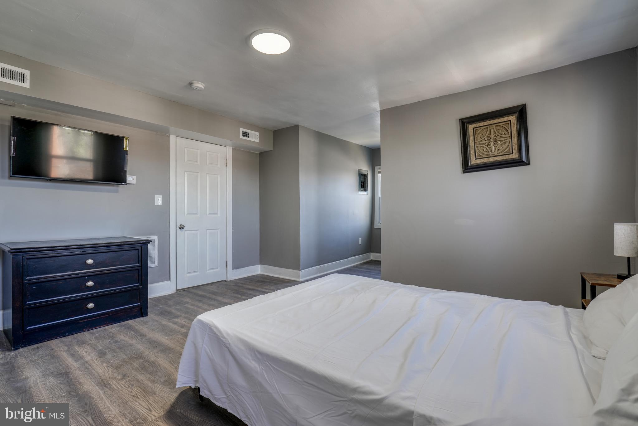 4107 Ridgewood Avenue Baltimore, MD 21215 - Photo 26 of 29 a bedroom with a bed and a flat screen tv