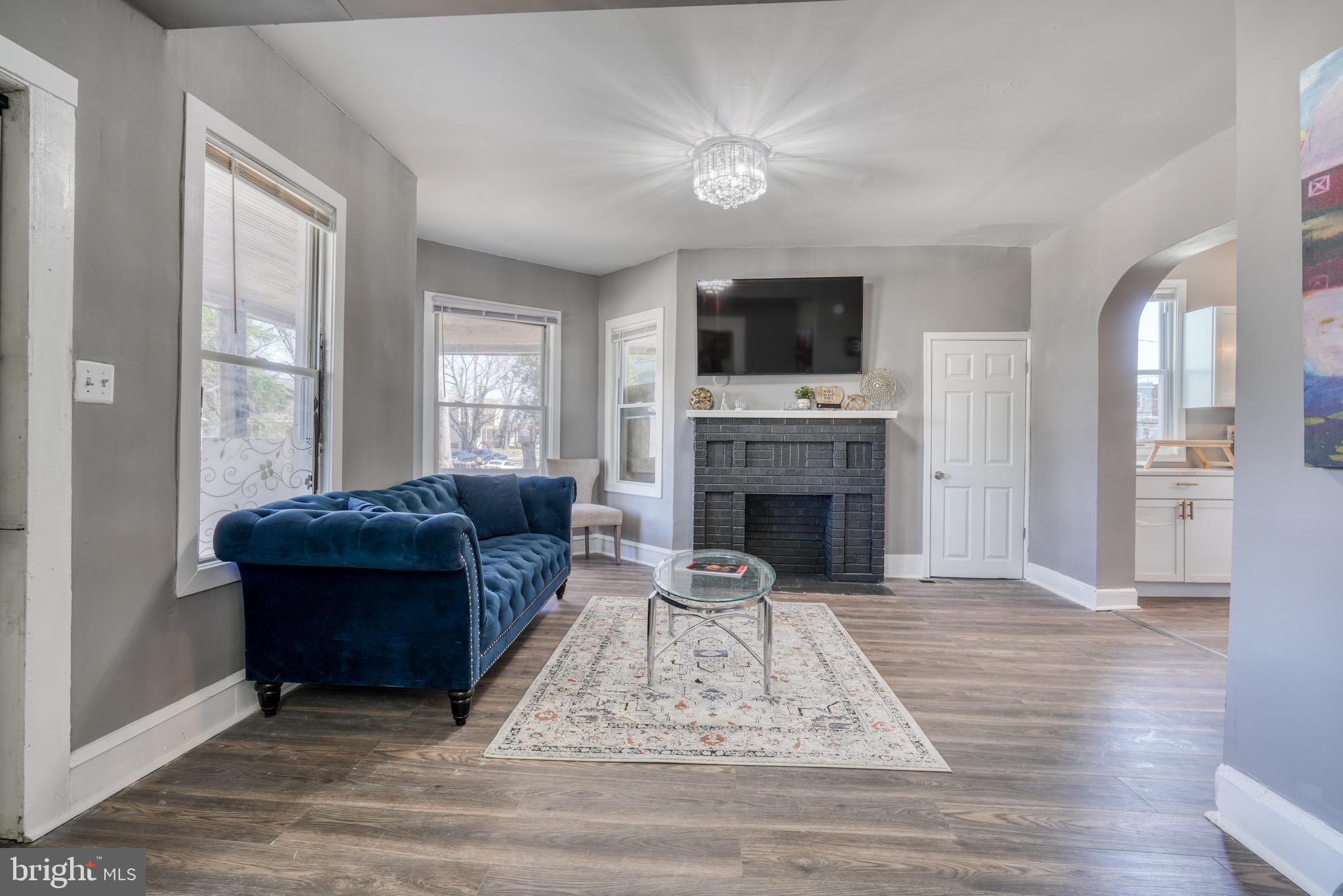 4107 Ridgewood Avenue Baltimore, MD 21215 - Photo 5 of 29 a living room with furniture a flat screen tv and a fireplace